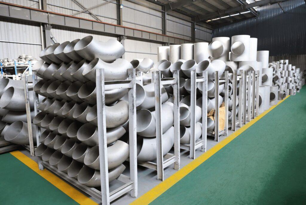 Racks of stainless steel butt-weld elbows and tees in the warehouse